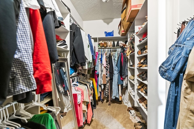 walk in closet with carpet