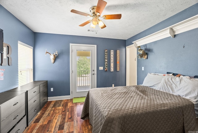 bedroom with visible vents, dark wood-type flooring, multiple windows, and access to exterior