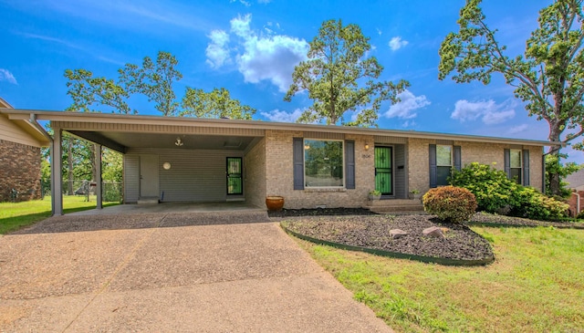 ranch-style house with concrete driveway, brick siding, a front yard, and an attached carport