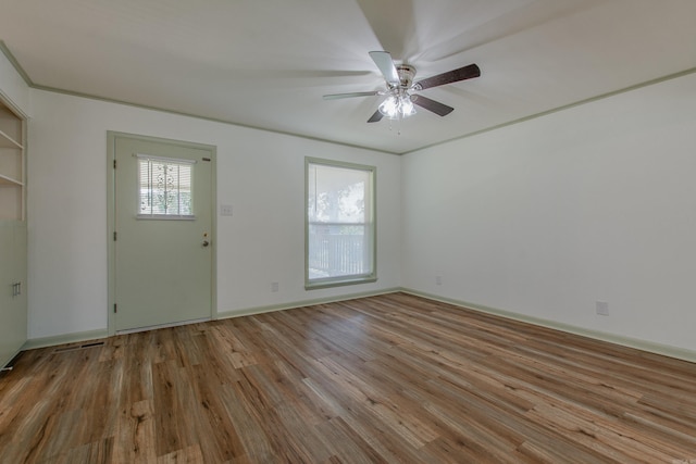 foyer entrance featuring baseboards, a ceiling fan, and light wood-style flooring