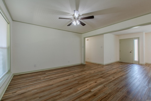 spare room with baseboards, a ceiling fan, and wood finished floors