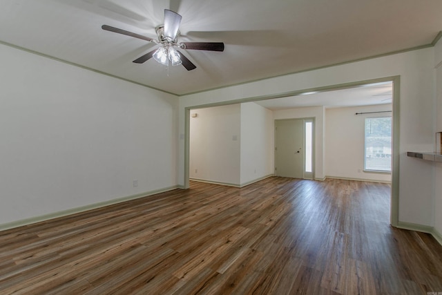 unfurnished room with baseboards, ceiling fan, and wood finished floors