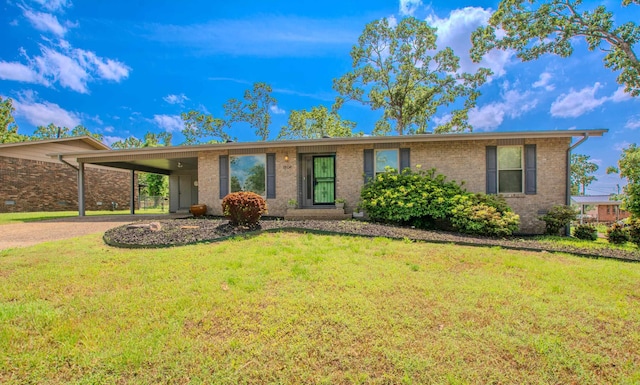 ranch-style home with brick siding, a front yard, and an attached carport