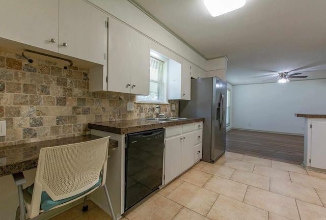 kitchen featuring a sink, stainless steel fridge with ice dispenser, dishwasher, white cabinetry, and decorative backsplash