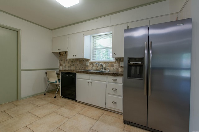 kitchen featuring decorative backsplash, a sink, stainless steel fridge, tile counters, and black dishwasher