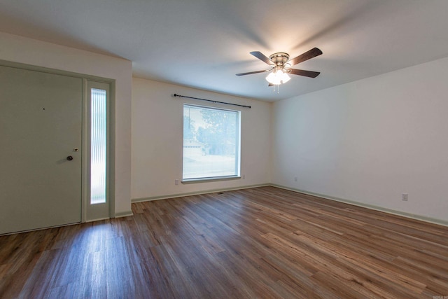 entryway featuring baseboards, a ceiling fan, and wood finished floors