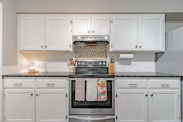 1321 W Front St, Heber Springs, AR 72543 - kitchen with under cabinet range hood, stainless steel range with electric cooktop, white cabinets, and dark stone countertops
