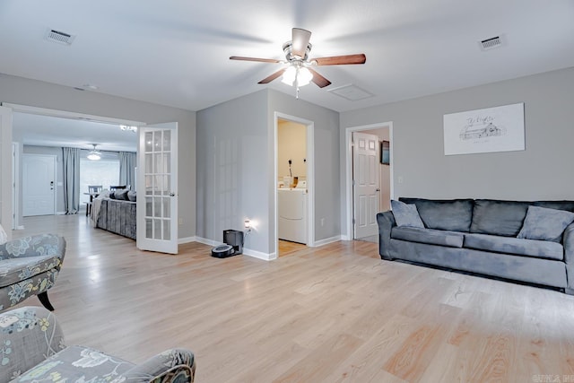 1321 W Front St, Heber Springs, AR 72543 - living room with french doors, a ceiling fan, washer / clothes dryer, visible vents, and light wood-type flooring