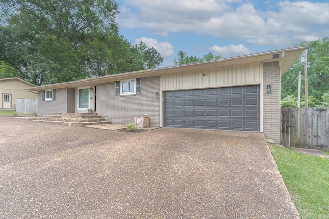 1321 W Front St, Heber Springs, AR 72543 - ranch-style house featuring brick siding, a garage, fence, and driveway