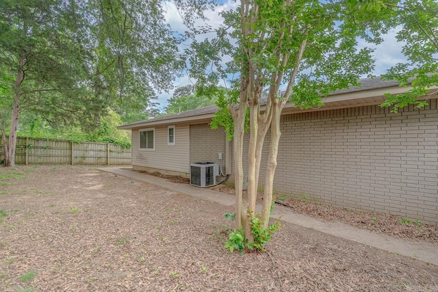 1321 W Front St, Heber Springs, AR 72543 - exterior space with brick siding, cooling unit, and a fenced backyard