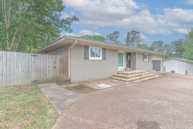 1321 W Front St, Heber Springs, AR 72543 - ranch-style house featuring fence, an attached garage, aphalt driveway, and brick siding