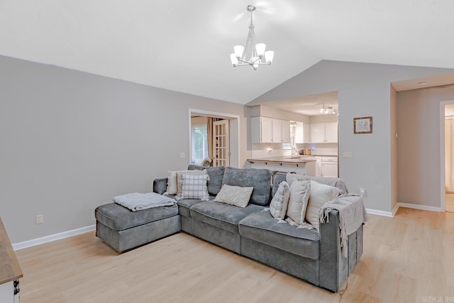 1321 W Front St, Heber Springs, AR 72543 - living room with baseboards, an inviting chandelier, lofted ceiling, and light wood-type flooring