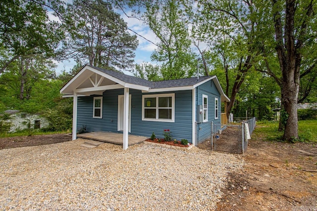 bungalow featuring covered porch and a shingled roof