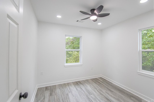 spare room featuring recessed lighting, visible vents, a wealth of natural light, and light wood-style floors