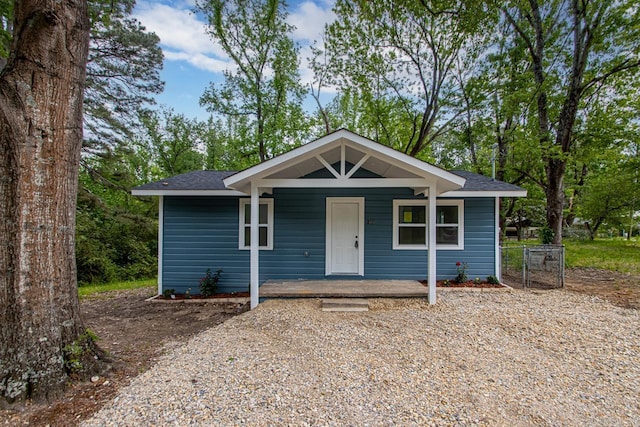 bungalow-style home with roof with shingles and covered porch