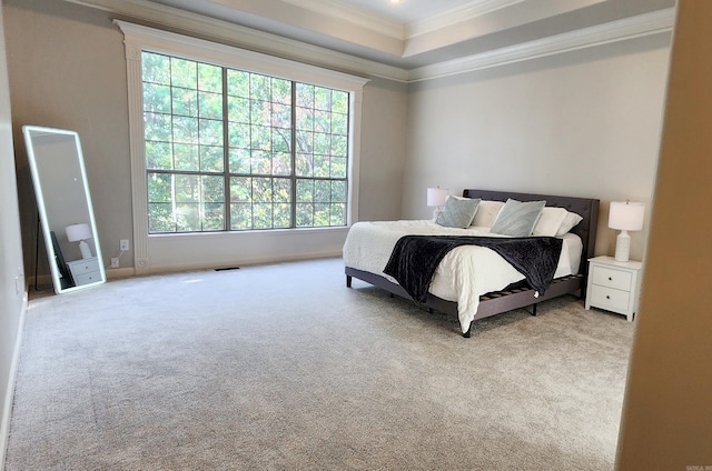 bedroom featuring visible vents, crown molding, baseboards, carpet, and a tray ceiling