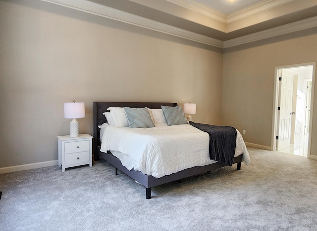 carpeted bedroom with baseboards, ornamental molding, and a raised ceiling