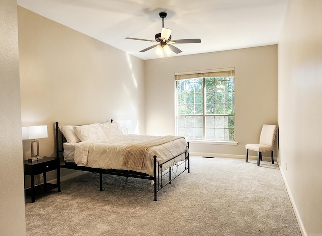 bedroom with baseboards, carpet flooring, a ceiling fan, and visible vents