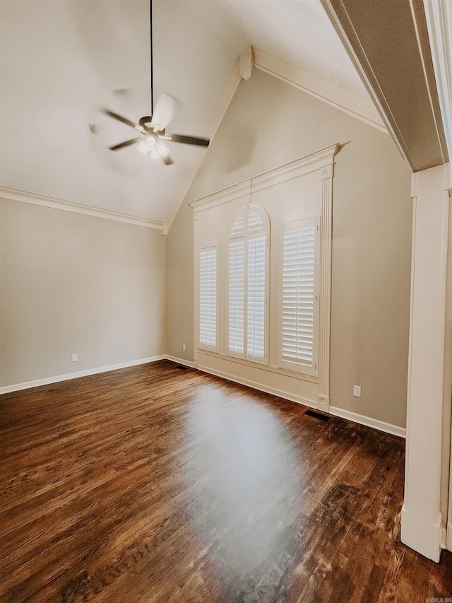 interior space with a ceiling fan, baseboards, vaulted ceiling with beams, dark wood-type flooring, and ornamental molding