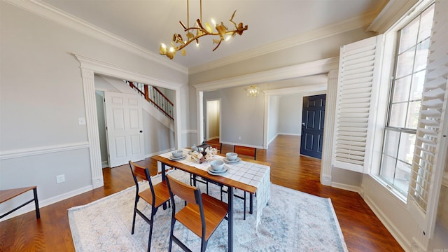 dining room with baseboards, wood finished floors, a chandelier, and stairway