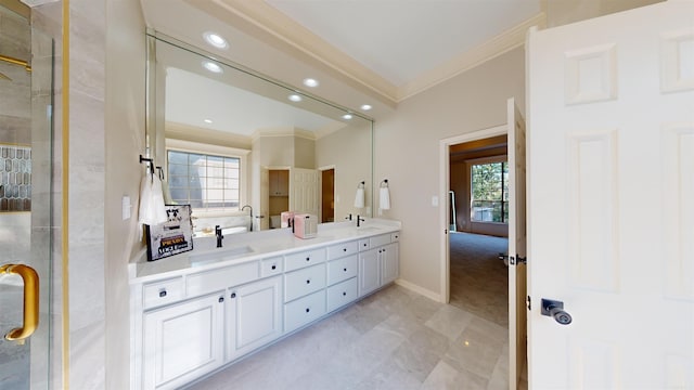 full bath with crown molding, double vanity, a shower stall, and a sink