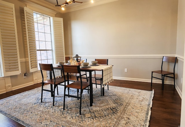 dining space featuring baseboards, ornamental molding, and dark wood-style floors