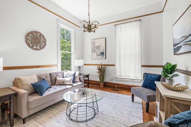 1509 S Spring, Little Rock, AR 72202 - living area with an inviting chandelier, baseboards, and wood finished floors