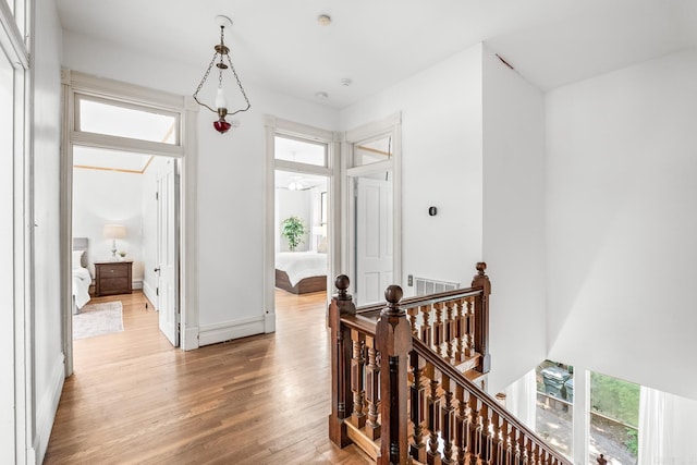 1509 S Spring, Little Rock, AR 72202 - hall with visible vents, light wood-style flooring, baseboards, and an upstairs landing