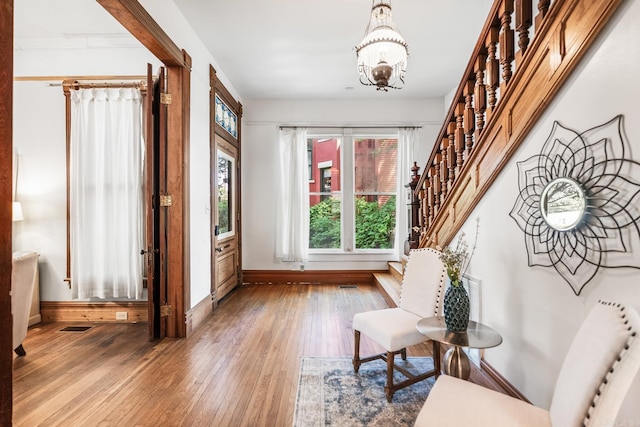 1509 S Spring, Little Rock, AR 72202 - interior space with an inviting chandelier, wood-type flooring, baseboards, visible vents, and stairway