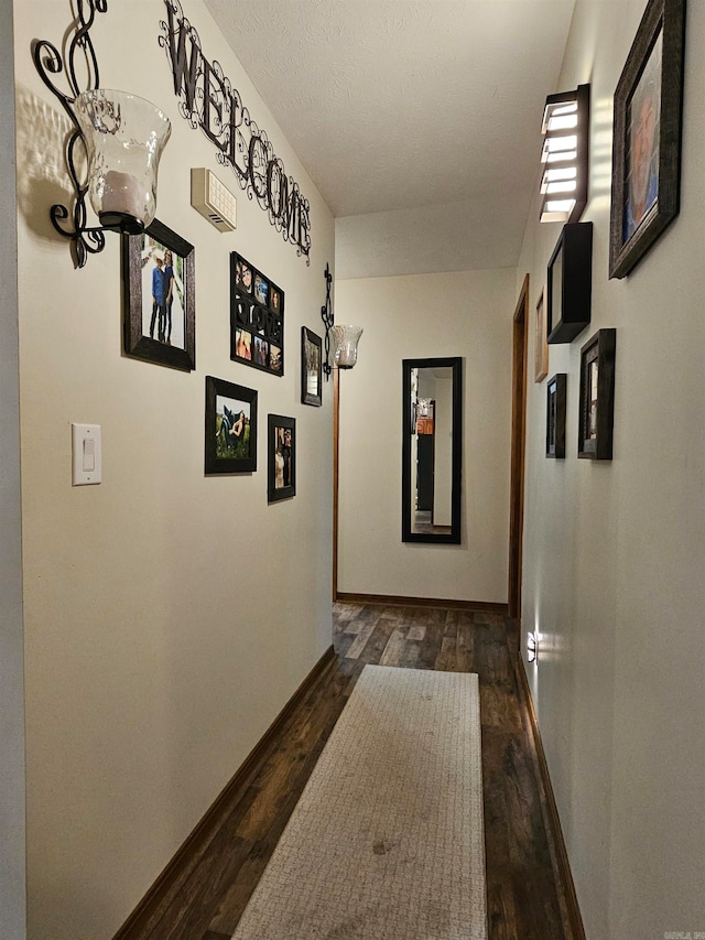 corridor with baseboards and dark wood-style floors