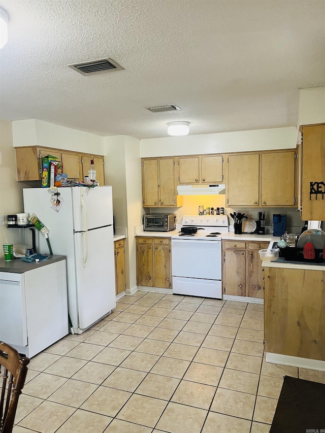 kitchen with white appliances, light countertops, light tile patterned floors, under cabinet range hood, and visible vents