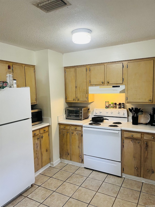 kitchen featuring visible vents, light countertops, a toaster, under cabinet range hood, and white appliances