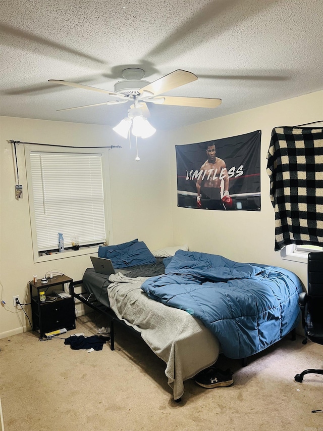 bedroom featuring carpet flooring, a textured ceiling, and ceiling fan