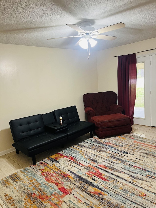 tiled living area featuring a textured ceiling and ceiling fan