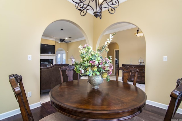 9241 Johnson Dr, Sherwood, AR 72120 - dining area featuring crown molding, arched walkways, and baseboards