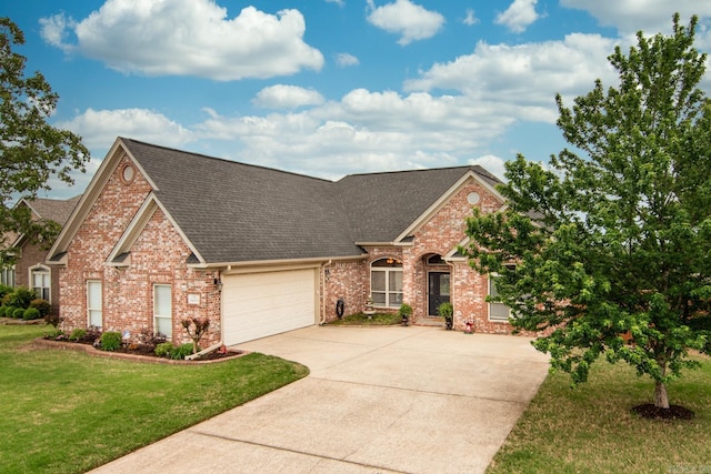9241 Johnson Dr, Sherwood, AR 72120 - traditional-style house featuring a garage, driveway, roof with shingles, and brick siding