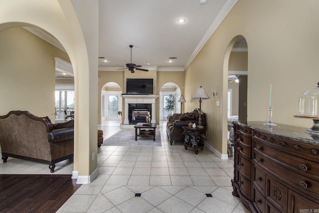 9241 Johnson Dr, Sherwood, AR 72120 - entryway with a ceiling fan, crown molding, arched walkways, baseboards, and a glass covered fireplace