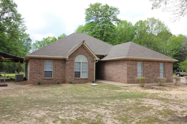 24076 Gracie Layne Ln, Bauxite, AR 72011 - ranch-style house featuring brick siding, central AC unit, roof with shingles, and a front lawn