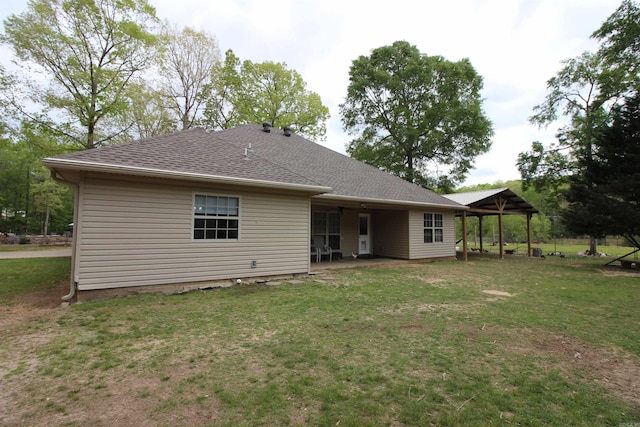 24076 Gracie Layne Ln, Bauxite, AR 72011 - rear view of property featuring a yard, roof with shingles, and a patio area