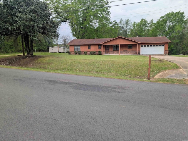 single story home featuring a garage, driveway, and a front yard