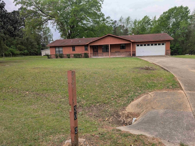 single story home with driveway, a front yard, and a garage