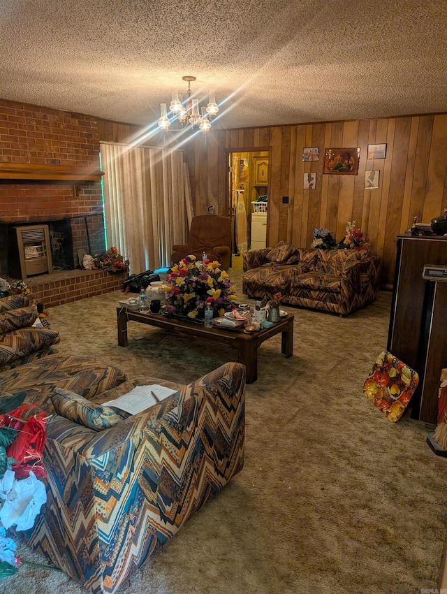 carpeted living area with wood walls, a textured ceiling, and a brick fireplace