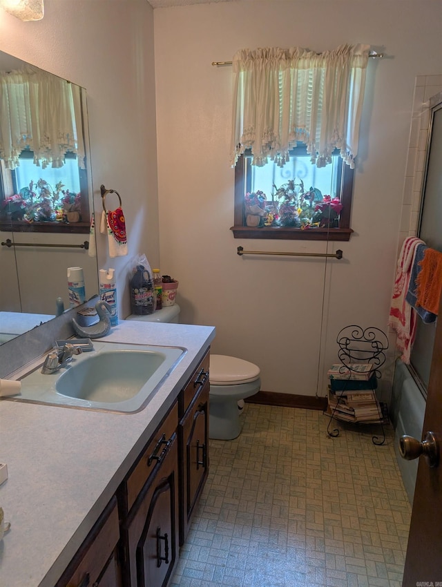 bathroom featuring vanity, toilet, and bathing tub / shower combination