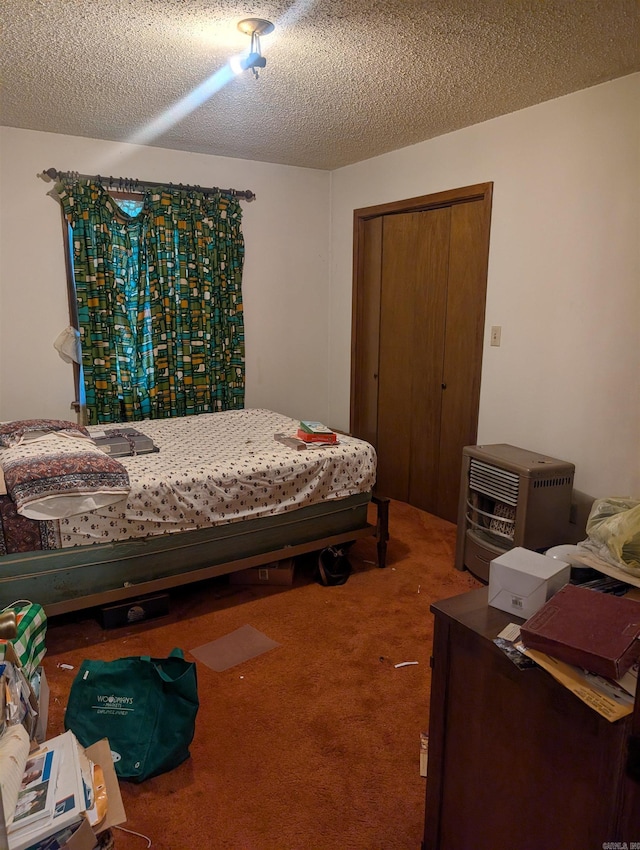 carpeted bedroom with a textured ceiling, heating unit, and a closet