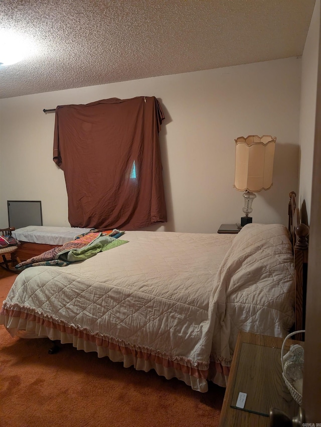carpeted bedroom featuring a textured ceiling