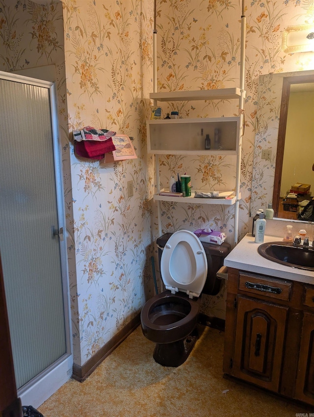 full bathroom with vanity, a shower stall, toilet, and wallpapered walls