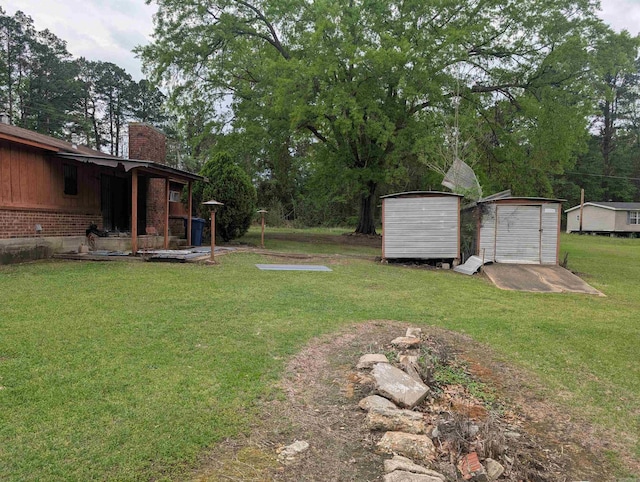 view of yard featuring an outbuilding and a shed
