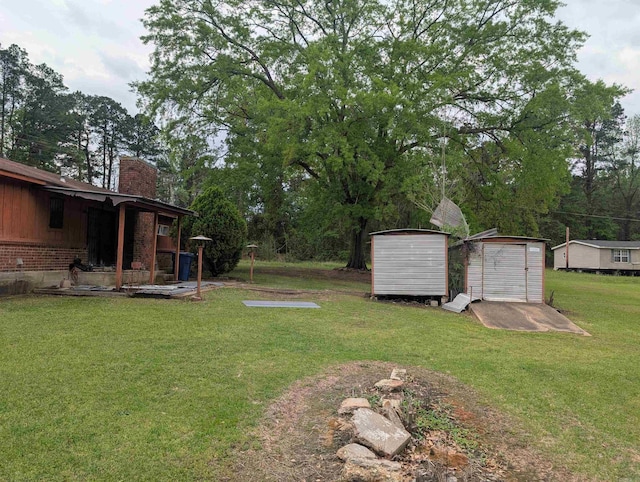 view of yard featuring a storage unit and an outbuilding