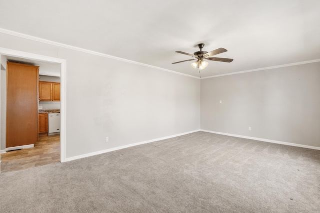 empty room featuring crown molding, a ceiling fan, baseboards, and light colored carpet