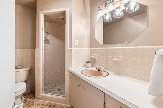 full bathroom with toilet, tile walls, wainscoting, and a stall shower